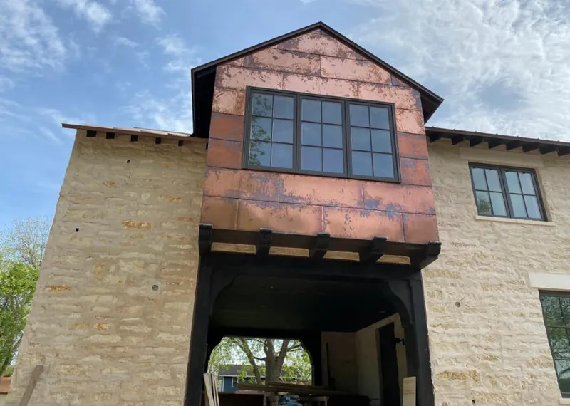 Copper metal panel facade on a stone building for Skylight Installation in Marco Island