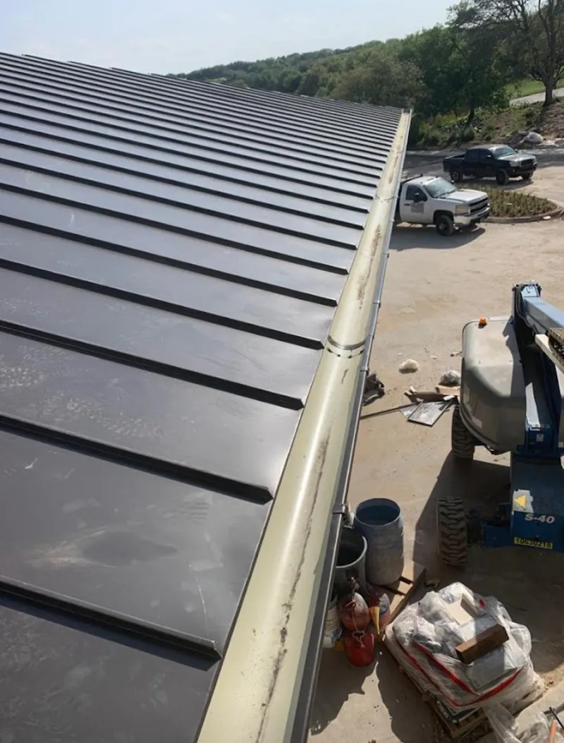 Standing seam panel and gutter detail on a metal roofing jobsite in Marco Island